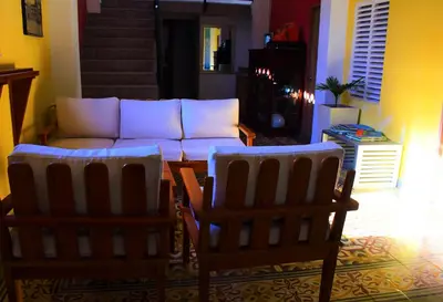 a living room with a couch and two chairs at Casa de la Cruz Centro Historico in Cartagena de Indias