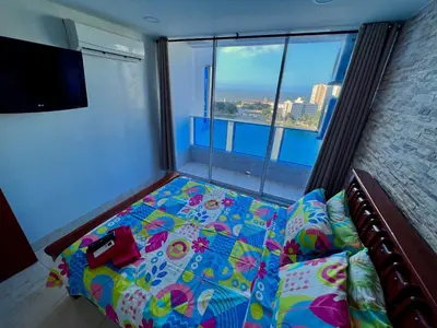 a bedroom with a bed and a large window at PyEnsa Cartagena in Cartagena de Indias
