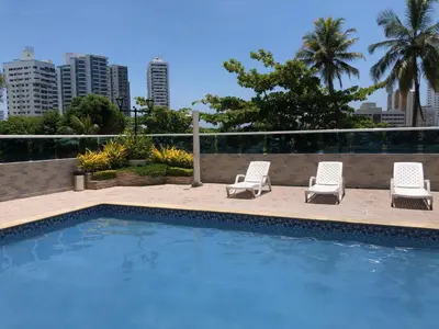a swimming pool with two chairs and a couple ofvisorvisor at PyEnsa Cartagena in Cartagena de Indias