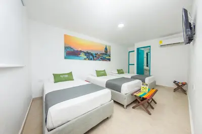 a bedroom with two beds and a tv in it at Hotel Ayenda Cartagena Blue 1804 in Cartagena de Indias