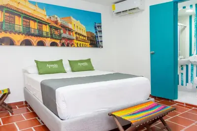 a bedroom with a bed and a painting on the wall at Hotel Ayenda Cartagena Blue 1804 in Cartagena de Indias