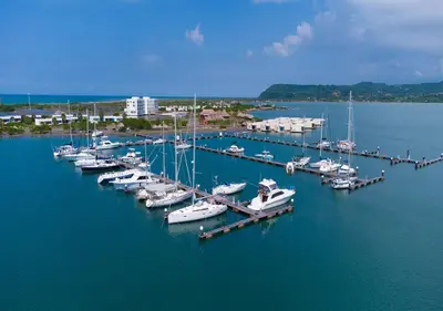 a group of boats docked at a dock in the water at Marina Puerto Velero in Tubará