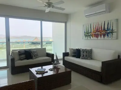 a living room with two couches and a table at Marina Puerto Velero in Tubará