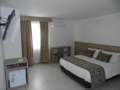 a hotel room with a bed and a television at Hotel Arawak Plaza in Sincelejo