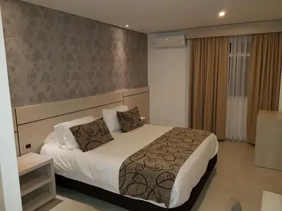 a bedroom with a bed in a hotel room at Hotel Arawak Plaza in Sincelejo