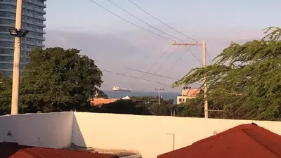 a cruise ship in the water in a city at host Casa Don Arturo in Santa Marta
