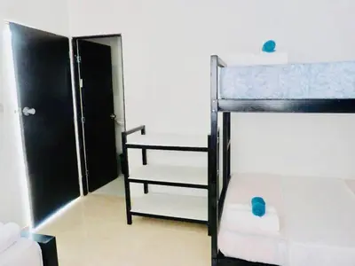 a small room with a bunk bed and a bunk bed at host Casa Don Arturo in Santa Marta