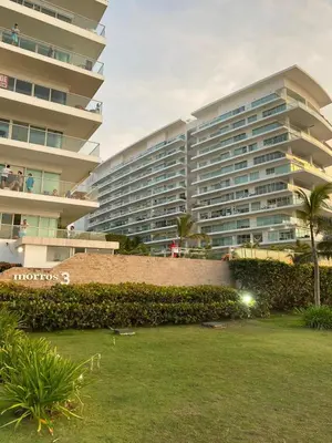 a large building with a lawn in front of it at Cartagena Morros 3 Playa in Cartagena de Indias