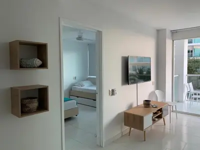 a room with a mirror and a table and a bed at Cartagena Morros 3 Playa in Cartagena de Indias