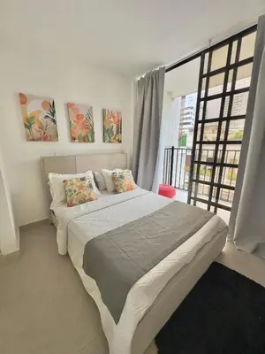 a bedroom with a large bed and a large window at Le MARIE B&B in Cartagena de Indias