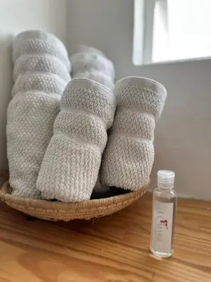 a basket of towels on a table with a bottle of soap at Le MARIE B&B in Cartagena de Indias