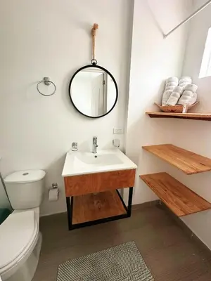 a bathroom with a sink and a toilet and a mirror at Le MARIE B&B in Cartagena de Indias
