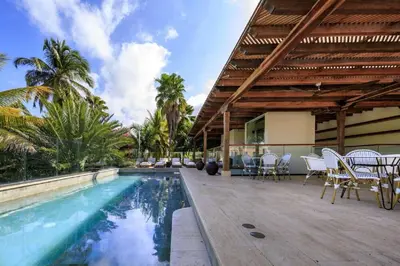 a house with a swimming pool and a patio with chairs at Eurostars Marqués de Villalta in Cartagena de Indias