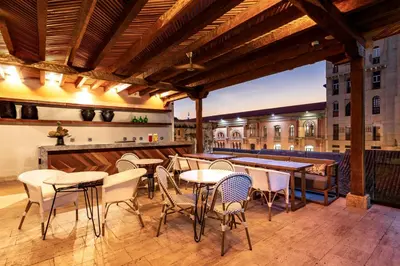 a patio with tables and chairs and a bar at Eurostars Marqués de Villalta in Cartagena de Indias