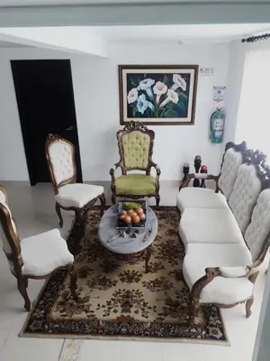 a living room with a couch and chairs and a table at Casa Hotel Manga Mar in Cartagena de Indias