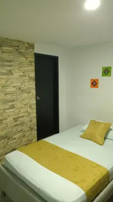 a bedroom with a bed with a black door at Casa Hotel Manga Mar in Cartagena de Indias