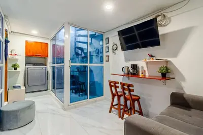 a living room with a couch and chairs and a tv at Casa Rachel in Cartagena de Indias