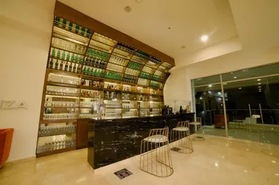 a room with a bar with a bunch of wine bottles at Hotel Dorado Plaza Alto Prado in Barranquilla
