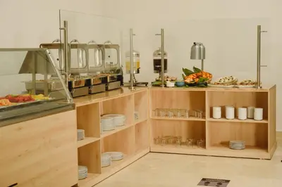 a kitchen with a buffet with plates and food at Hotel Dorado Plaza Alto Prado in Barranquilla