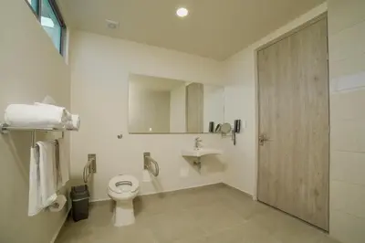 a bathroom with a toilet and a sink at Hotel Dorado Plaza Alto Prado in Barranquilla