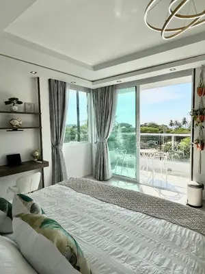 a bedroom with a bed and a large window at Ritacuba House Boutique in Santa Marta