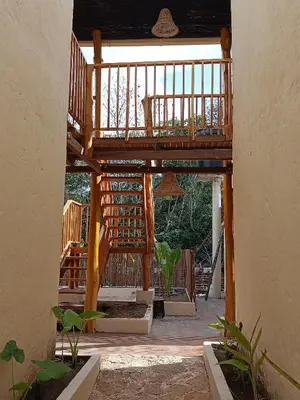 a wooden house with a deck with a balcony at Paraíso Natural Ecohotel in San Bernardo del Viento