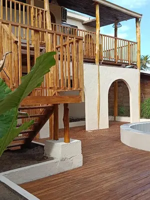 a wooden deck with a wooden staircase in a house at Paraíso Natural Ecohotel in San Bernardo del Viento