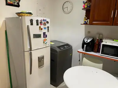 a kitchen with a refrigerator and a microwave at APARTMENT WHITE BOCAGRANDE - Los Delfines in Cartagena de Indias