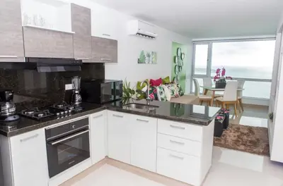 a kitchen with white cabinets and a view of the ocean at Modern 1BR WiFi Breathtaking Oceanviews by Huespedia in Cartagena de Indias