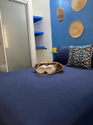 a blue bedroom with a bed with a bowl on it at Casa San Juan in Cartagena de Indias