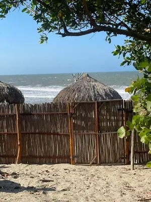 a fence on the beach next to a beach at Eco Xata in Santa Veronica