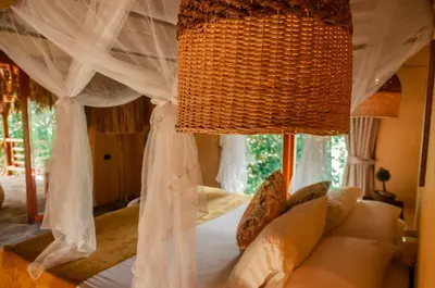 a bedroom with a canopy bed with white curtains at Eco Xata in Santa Veronica