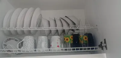 a shelf with plates and cups on it at Comodo Apartamento en Bocagrande Cartagena 801B in Cartagena de Indias