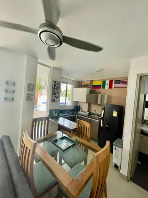 a kitchen and dining room with a table and chairs at Costa Serena Casa 3 in Coveñas