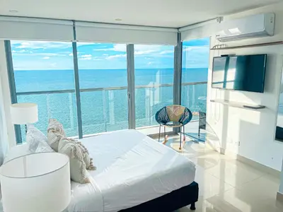 a bedroom with a bed and a view of the ocean at 22nd flr Spectacular Seaview Morros City Bocagrande in Cartagena de Indias