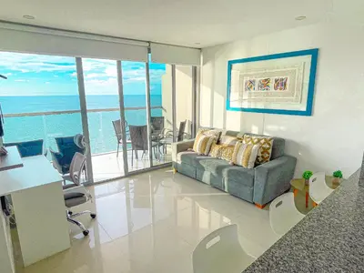 a living room with a couch and a view of the ocean at 22nd flr Spectacular Seaview Morros City Bocagrande in Cartagena de Indias