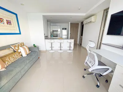 a living room with a couch and a chair at 22nd flr Spectacular Seaview Morros City Bocagrande in Cartagena de Indias