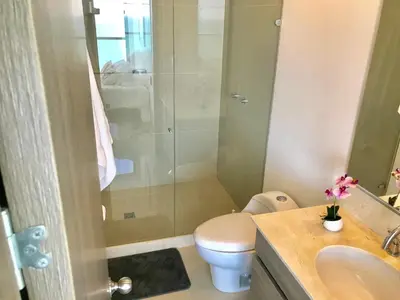 a bathroom with a toilet and a sink and a shower at 22nd flr Spectacular Seaview Morros City Bocagrande in Cartagena de Indias