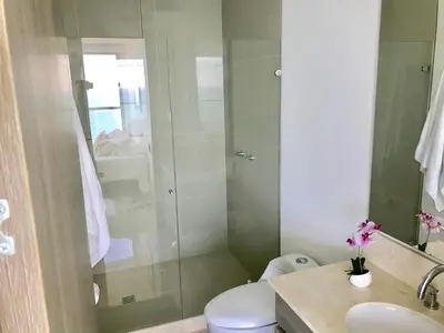 a bathroom with a shower with a toilet and a sink at 22nd flr Spectacular Seaview Morros City Bocagrande in Cartagena de Indias
