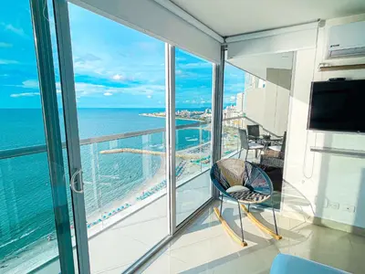 a balcony with a chair and a view of the ocean at 22nd flr Spectacular Seaview Morros City Bocagrande in Cartagena de Indias