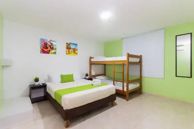 a bedroom with a bed and a bunk bed at Hotel Avexi Suites By GEH Suites in Cartagena de Indias
