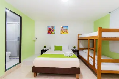 a bedroom with a bunk bed and a bathroom at Hotel Avexi Suites By GEH Suites in Cartagena de Indias