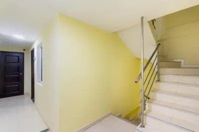 a hallway with stairs and a black door at Hotel Avexi Suites By GEH Suites in Cartagena de Indias