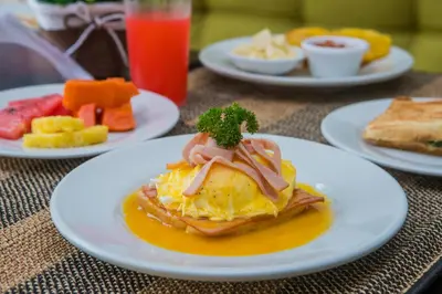 a table with plates of breakfast food on it at Hotel Avexi Suites By GEH Suites in Cartagena de Indias