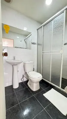 a bathroom with a toilet and a sink and a shower at Hotel Balcones de Bocagrande in Cartagena de Indias