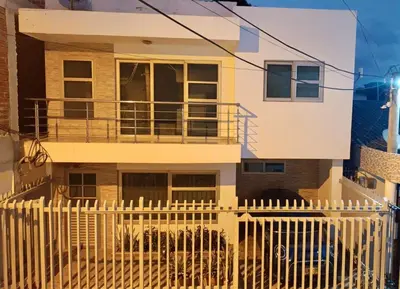 a house with a white fence in front of it at Apartamento la Isla 1-Coveñas in Coveñas