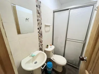 a bathroom with a toilet and a sink and a shower at Apartamento la Isla 1-Coveñas in Coveñas