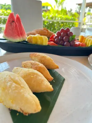 a plate of food with fruit on a table at Santo Manglar Cartagena Life Wellness Spa Hotel in Cartagena de Indias