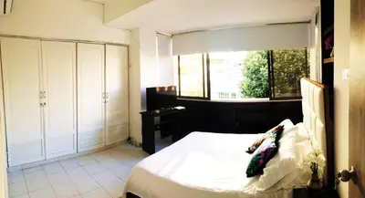 a bedroom with a white bed and a window at SAN JACINTO HOSTEL in Cartagena de Indias
