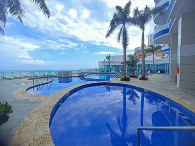 a swimming pool with a view of the ocean at Apartamentos Palmetto - Frente al Mar in Cartagena de Indias